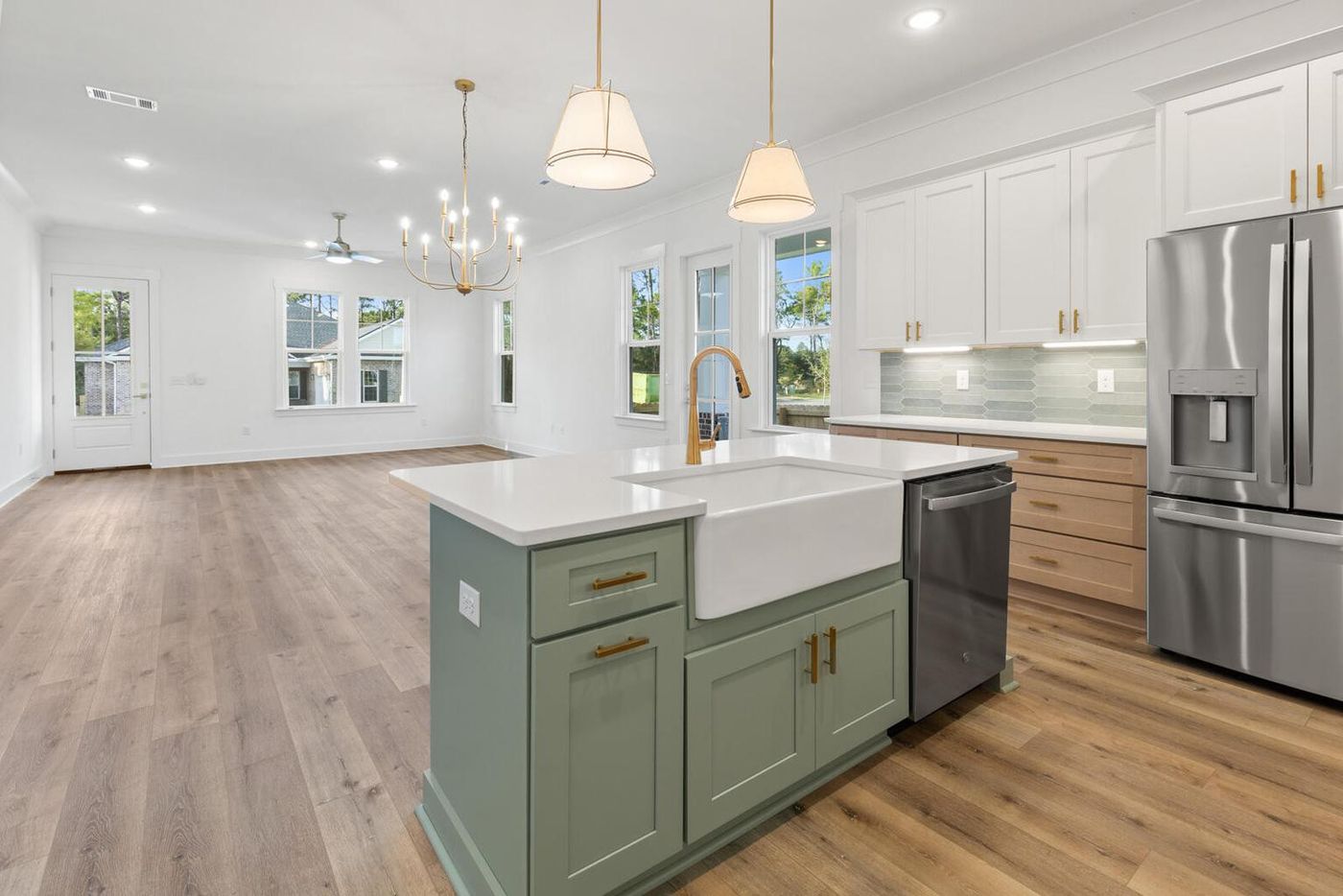 Kitchen with a sage island and farmhouse sink