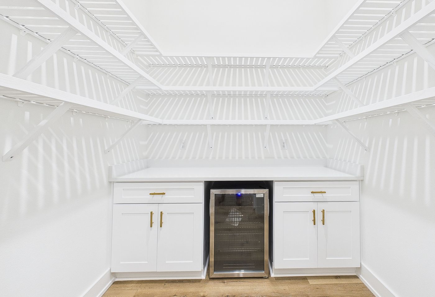 Walk-in closet with a built-in wine fridge