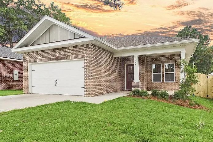 Brick home at sunset with a two-car garage at 1496 Pine St, Niceville